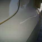 Before and after photographs of a damaged white, AUDI Quattro SUV that was repaired by Elite Paint & Body Shop in West Palm Beach, Florida.